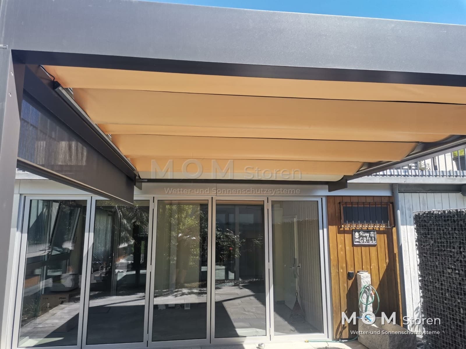 Beige shading in front of wide glazing