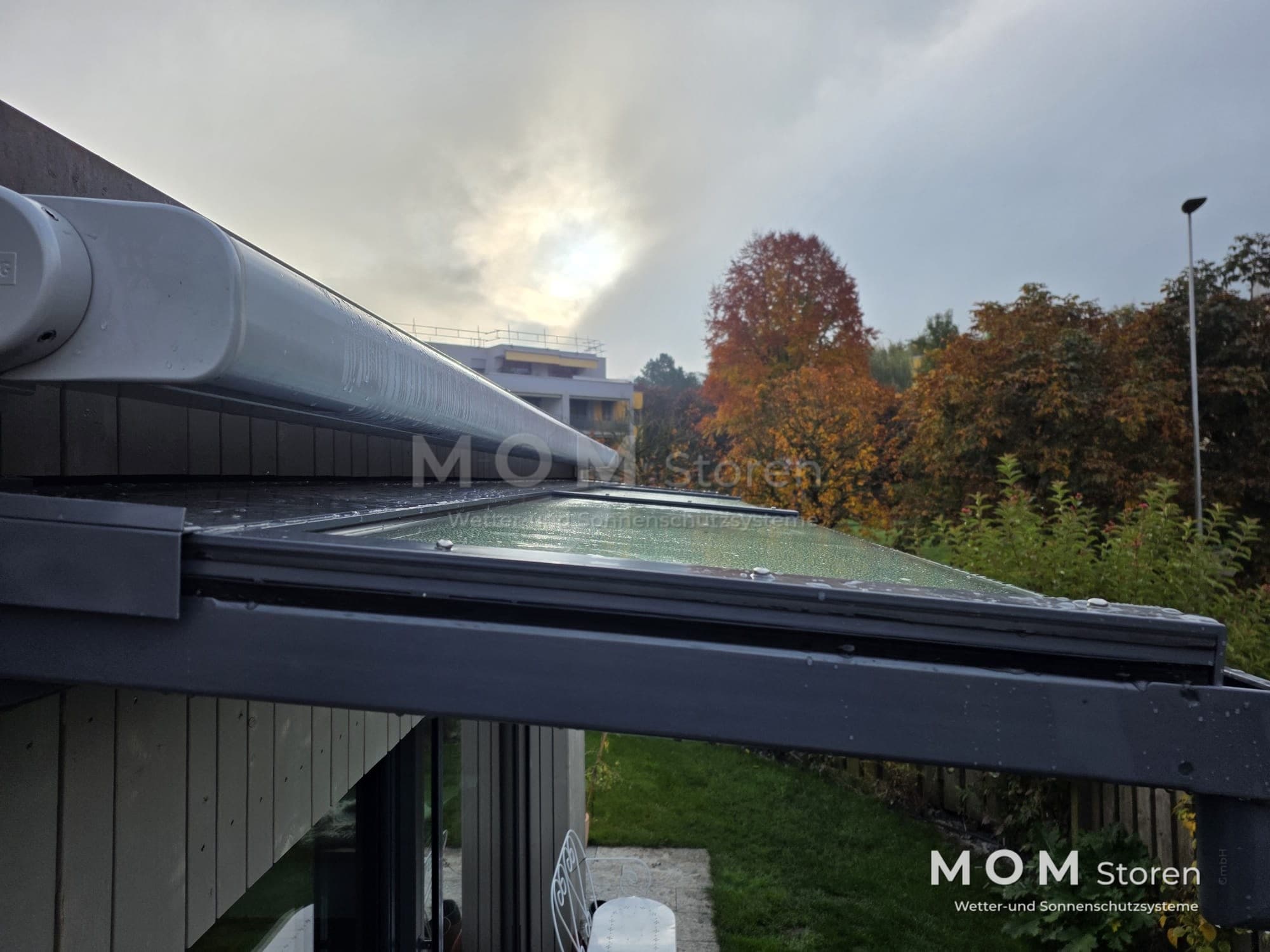 Awning cassette above a glazed terrace side