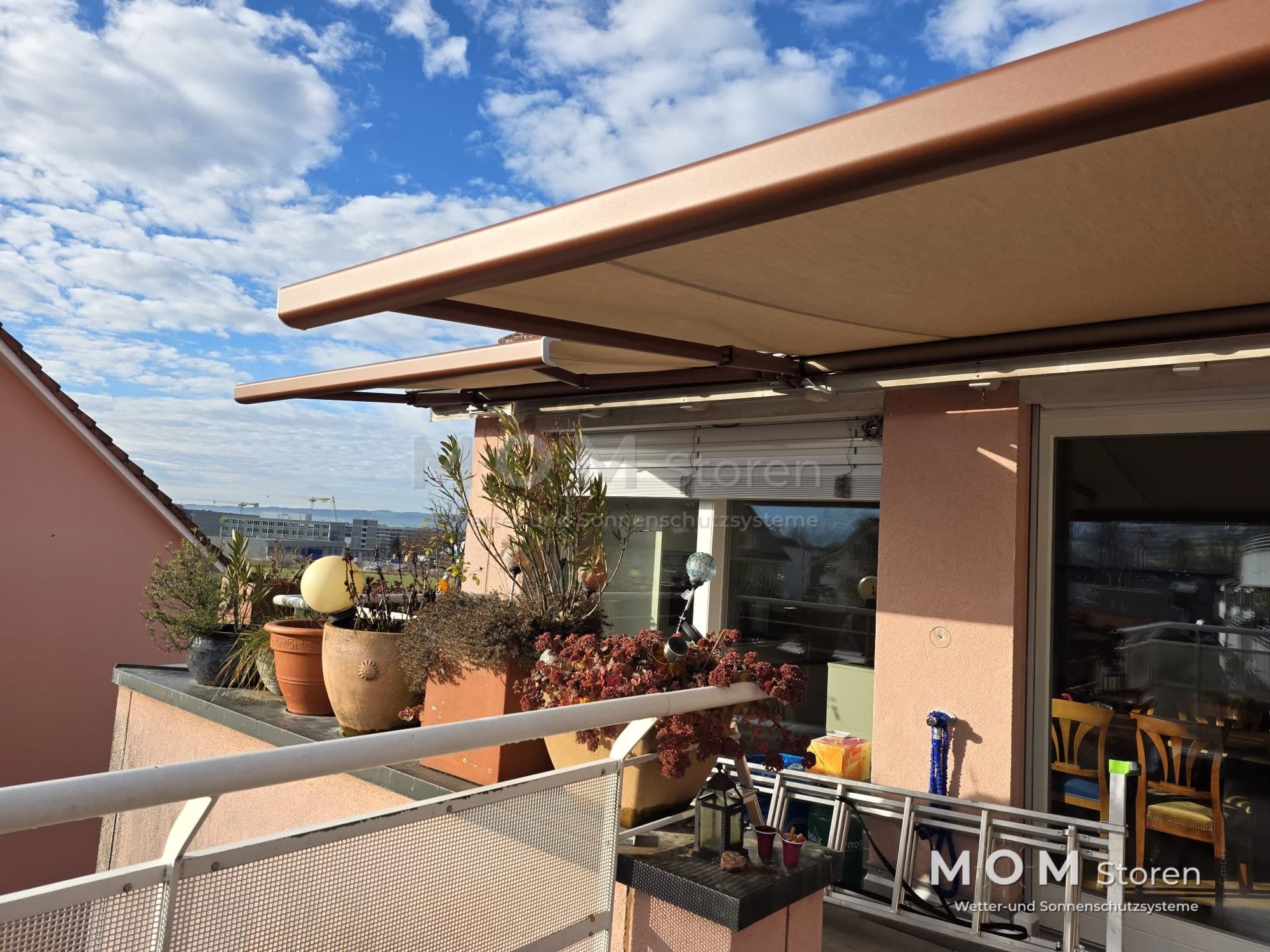 Beige balcony awning with plants and seating