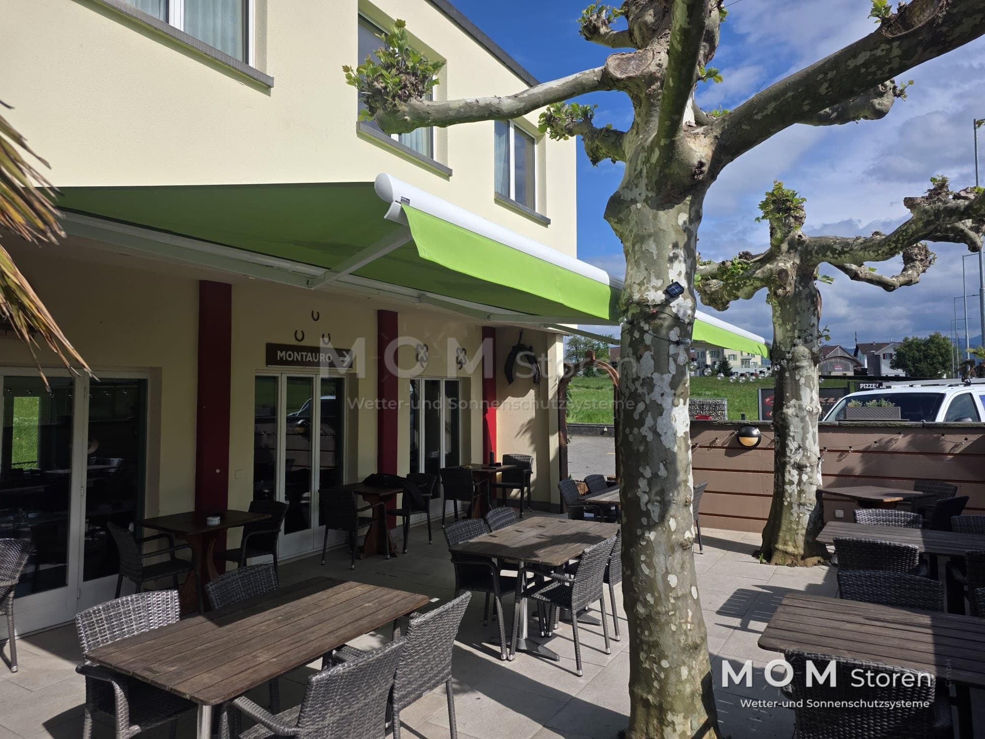 Green awnings along a hospitality terrace