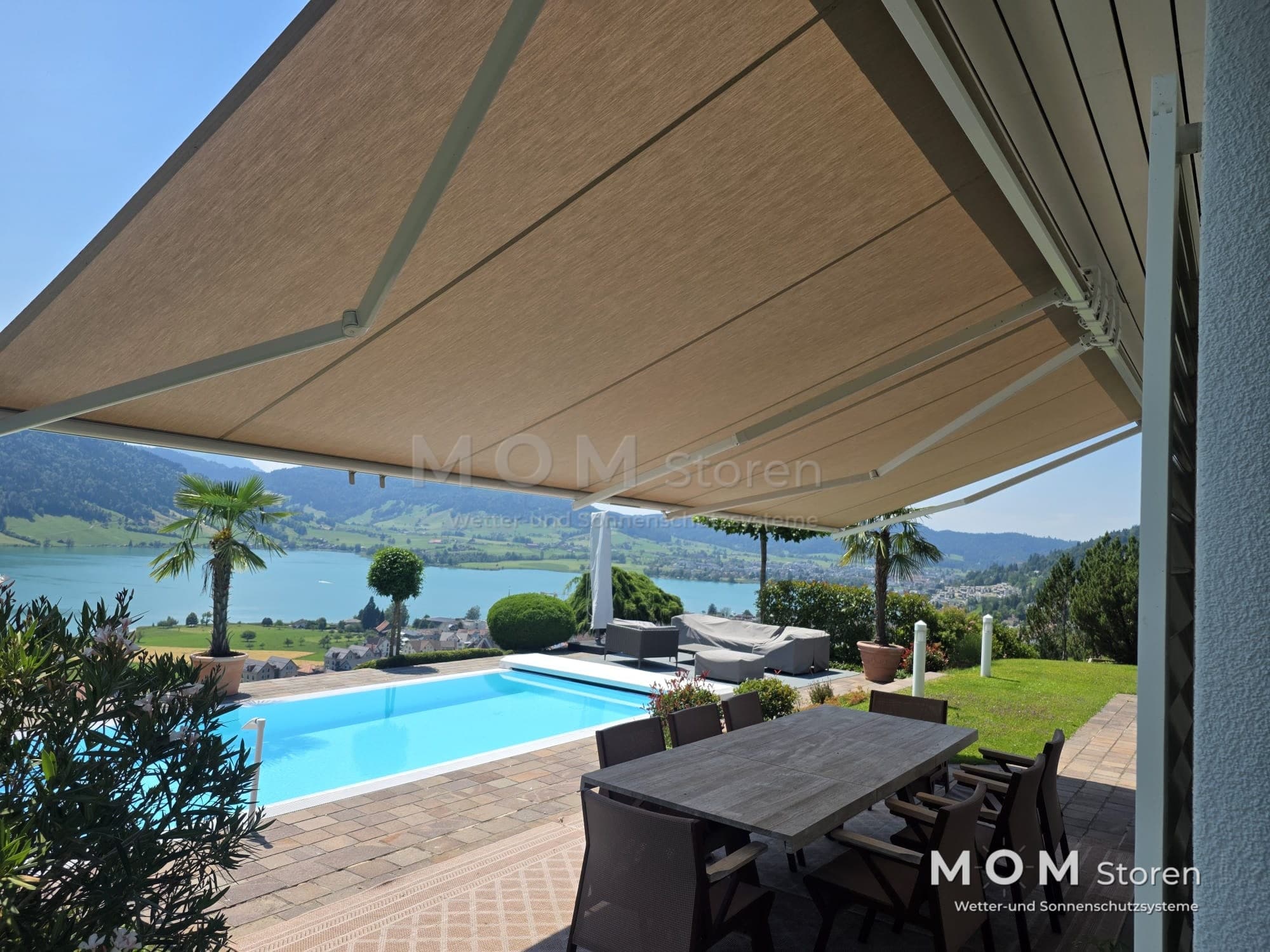 Beige awning over seating beside a pool