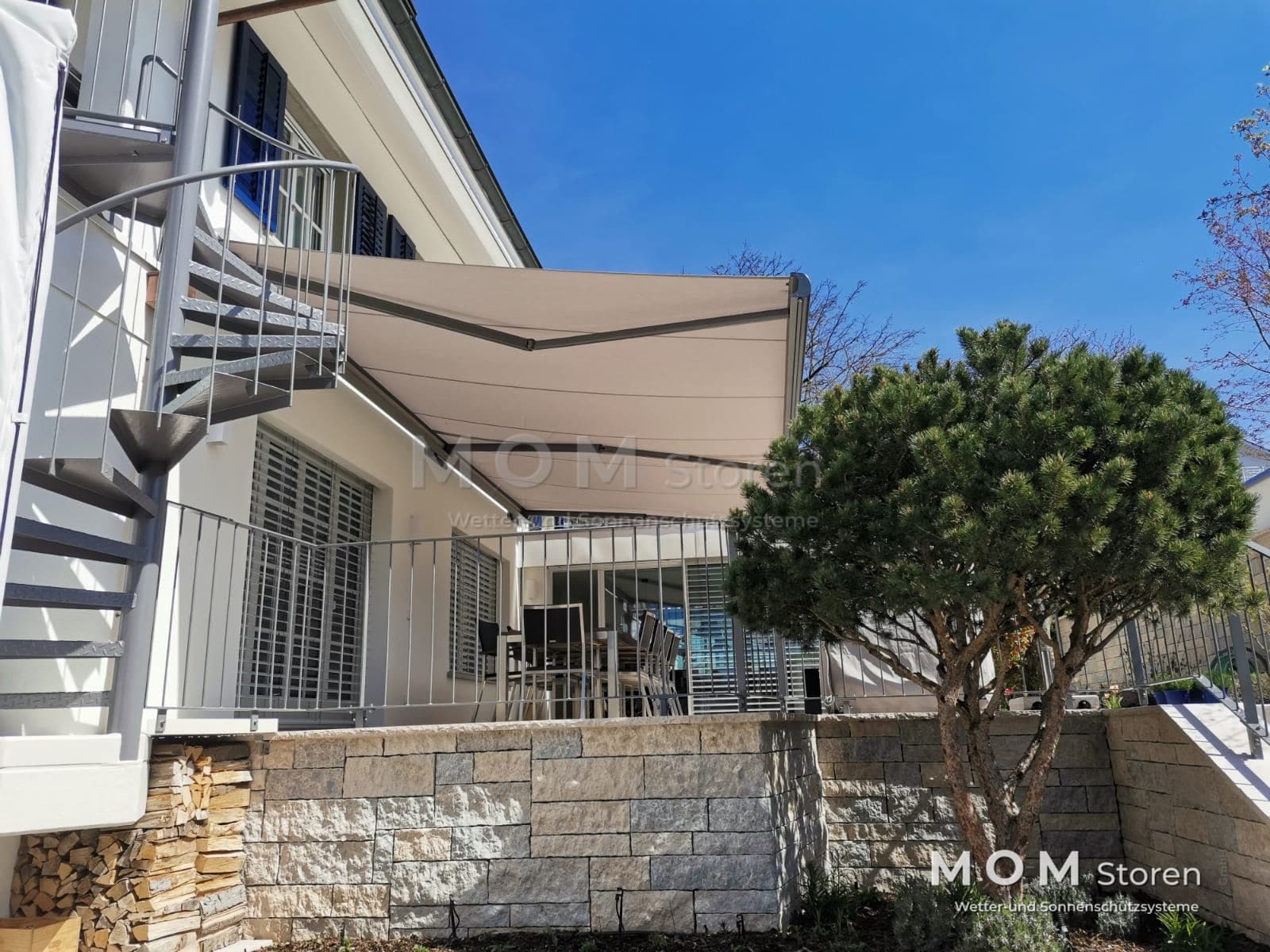 Light awning over a terrace with a stone base
