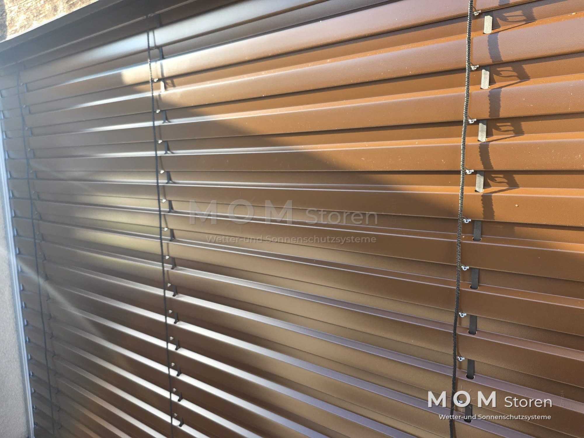 Detail of light slats in front of a window
