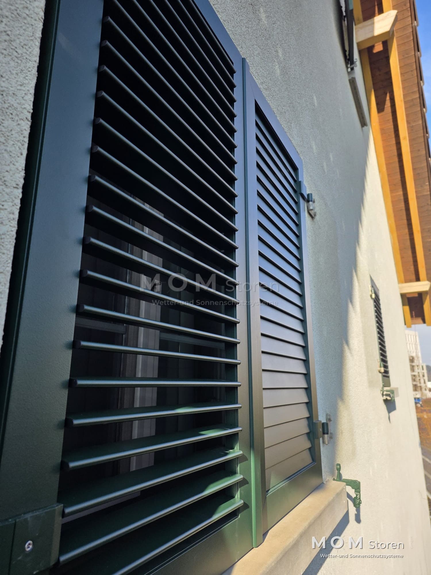 Dark external blinds beside a timber window