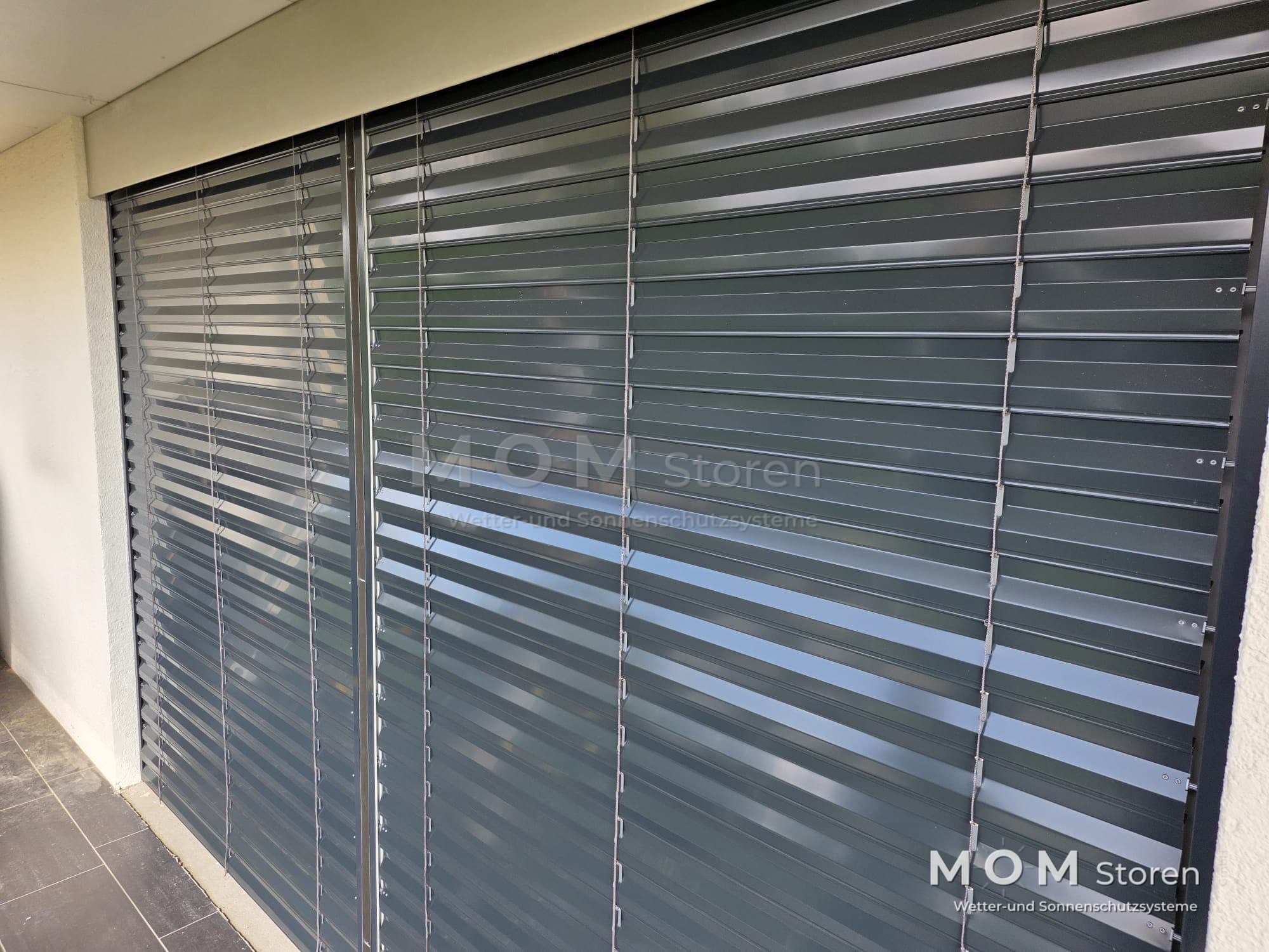 Grey external slats across a wide window